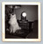 white persian cat sitting on desk by book set clock and lamp