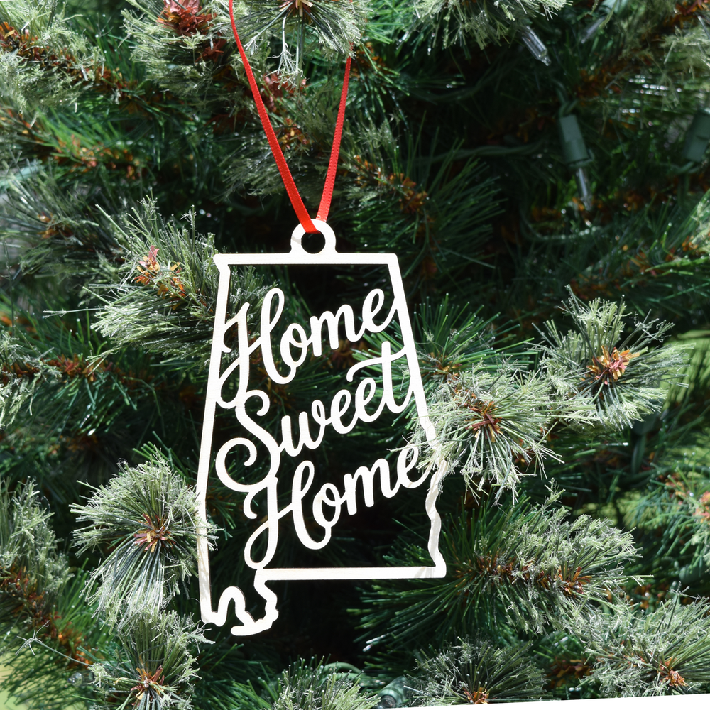 Home Sweet Home Alabama wooden ornament featuring an Alabama state silhouette with elegant script lettering, natural wood finish, and ribbon hanger. (Ribbon Color May Vary)