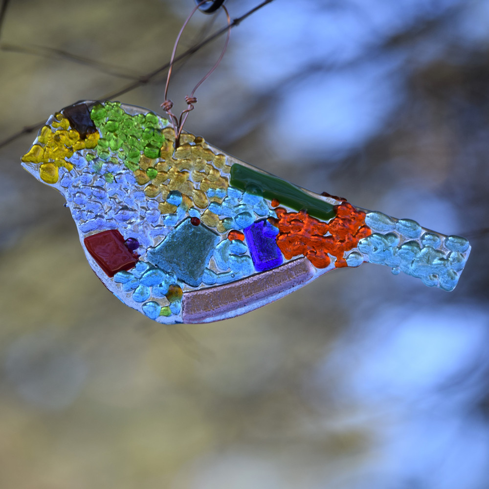 Handcrafted fused glass bird ornament and suncatcher made in Alabama, colorful hanging glass bird artwork for windows, home décor, and gifts