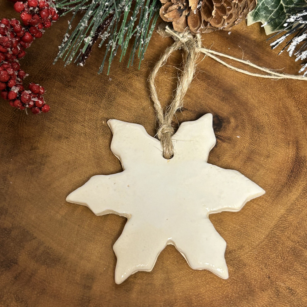 Handcrafted snowflake ornament hanging on Christmas tree, made in Alabama, elegant winter holiday décor, artisan gift idea