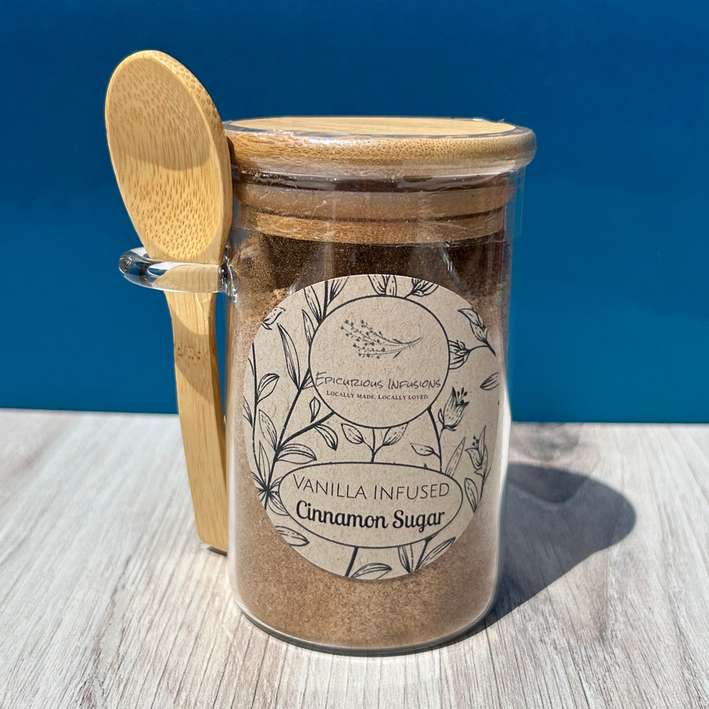 Vanilla infused cinnamon sugar jar close-up on rustic kitchen counter with warm tones and baking ingredients