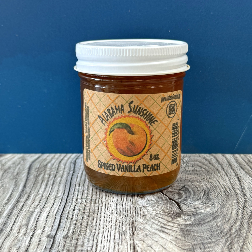 Alabama-made vanilla peach pepper jam with bourbon flavor in glass jar, sweet and spicy gourmet spread for cheese boards and gifts