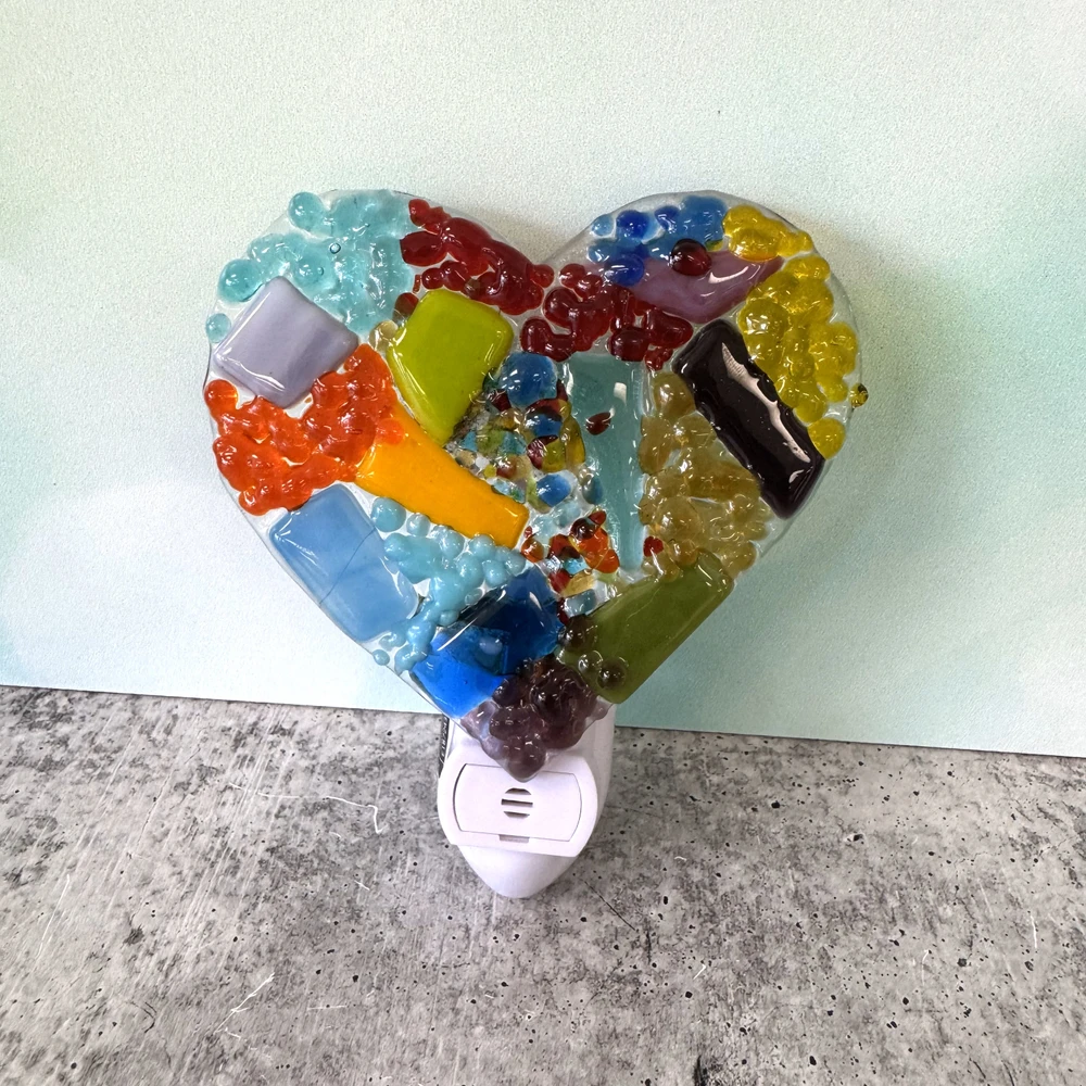 Heart-shaped glass night light with warm ambient lighting