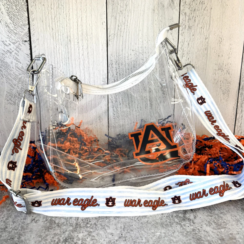 Clear Auburn University gameday bag with white trim and adjustable strap, stadium-approved crossbody purse with Auburn icons and gold hardware