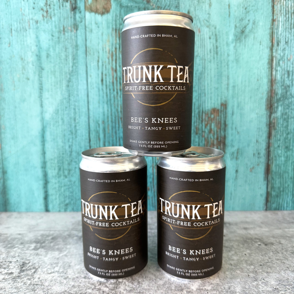Refreshing non-alcoholic Bee’s Knees cocktail with lemon, honey, and juniper, beautifully bottled for an elegant alcohol-free drink experience