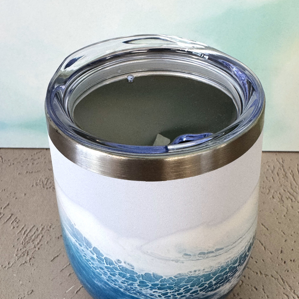 Ocean-inspired hand-painted wine tumbler with turquoise and blue coastal wave design, insulated stainless steel drinkware for wine, cocktails, and beach gifts