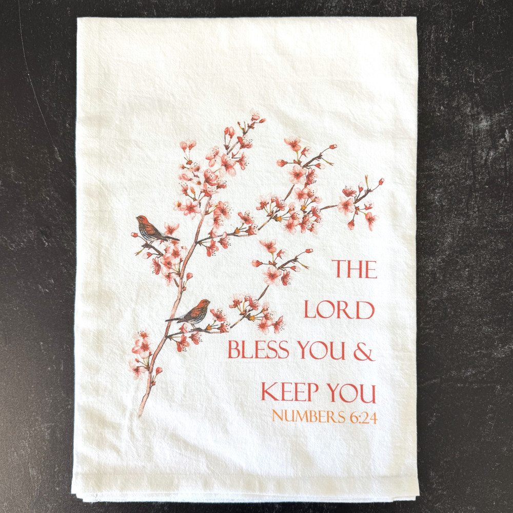 Soft cotton tea towel with birds, cherry blossoms, and Numbers 6:24 Bible verse displayed in a kitchen setting