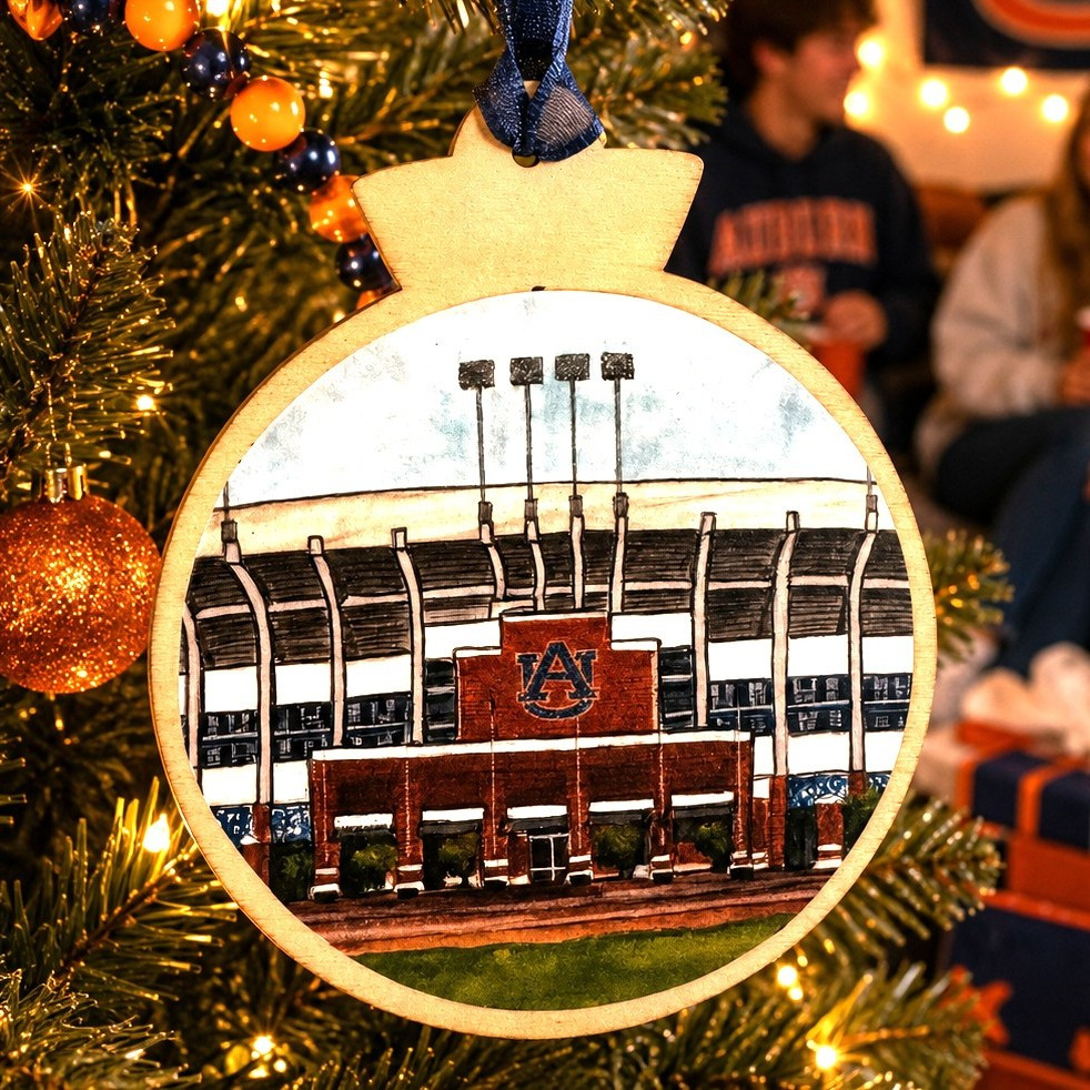 Jordan-Hare Stadium wooden ornament featuring detailed Auburn University stadium artwork, natural wood frame, and blue hanging ribbon.