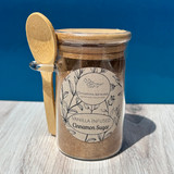 Vanilla infused cinnamon sugar jar close-up on rustic kitchen counter with warm tones and baking ingredients