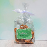 Crispy golden peanut brittle candy pieces made in Alabama, gourmet Southern sweet, close-up of crunchy texture and roasted peanuts