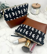 Alabama-made makeup bag in waxed canvas and vegan leather, available in floral and navy, perfect for travel, toiletries, and gift giving.