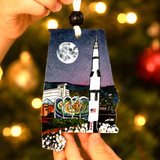 Alabama-shaped Christmas ornament featuring the U.S. Space & Rocket Center and Saturn V rocket in Huntsville, Alabama under a moonlit sky