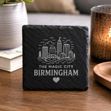 Magic City Birmingham black slate drink coaster featuring an engraved city skyline and rustic stone texture, ideal for Birmingham gifts and home décor.