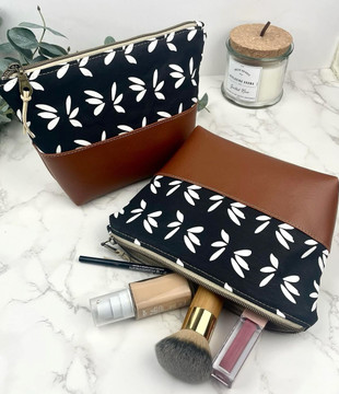 Alabama-made makeup bag in waxed canvas and vegan leather, available in floral and navy, perfect for travel, toiletries, and gift giving.