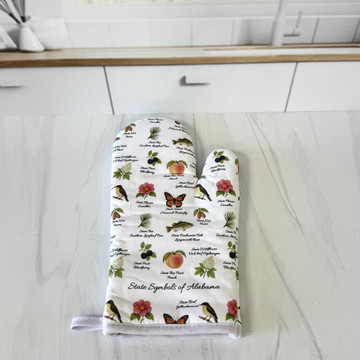 Alabama state symbols oven mitt with yellowhammer bird and camellia flower design hanging in a Southern kitchen