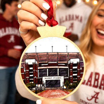 Bryant-Denny Stadium wooden ornament featuring detailed University of Alabama football stadium artwork, natural wood frame, and red hanging ribbon.