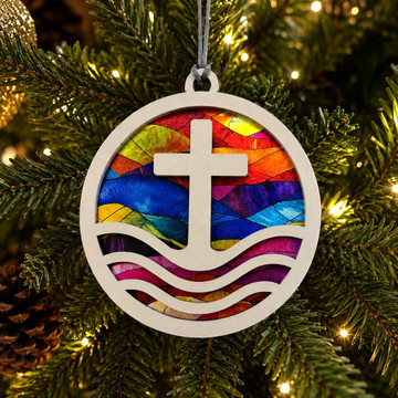 Cross and waves Christian ornament with colorful stained glass-inspired artwork, round wood design, and hanging cord. Made in Alabama for Christmas and year-round faith décor.