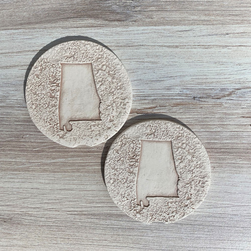 Alabama clay car coasters set in cup holder, absorbent clay car coaster close-up, handmade Alabama car accessories, natural clay cup holder coaster detail