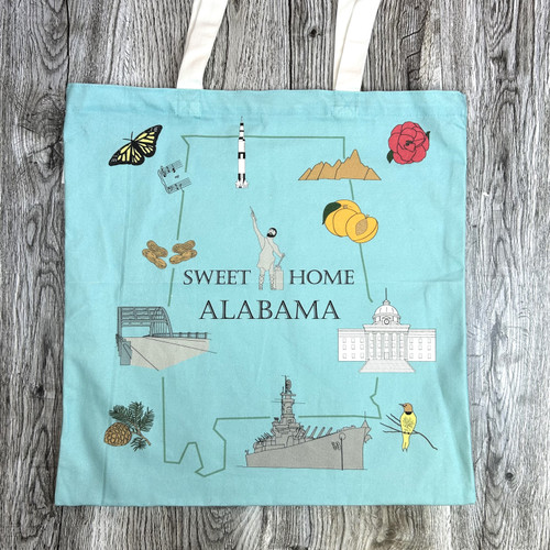 Alabama landmarks tote bag with Vulcan statue, state capitol, USS Alabama, camellia flower, yellowhammer bird, and longleaf pine design on reusable foldable shopping bag