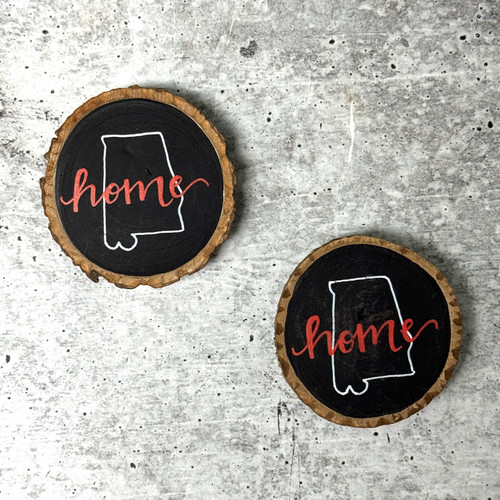 Home magnet with “Home” design on a refrigerator in a cozy kitchen setting