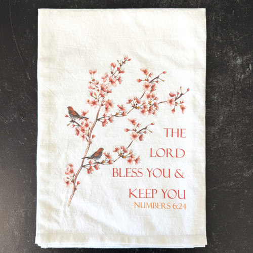 Soft cotton tea towel with birds, cherry blossoms, and Numbers 6:24 Bible verse displayed in a kitchen setting