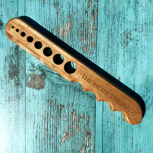 Wooden herb stripper tool with multiple hole sizes for removing leaves from herbs like rosemary and thyme, natural wood kitchen tool for home cooks