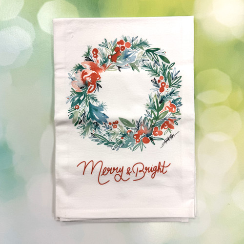 Merry & Bright wreath towel hanging on oven handle in festive kitchen décor