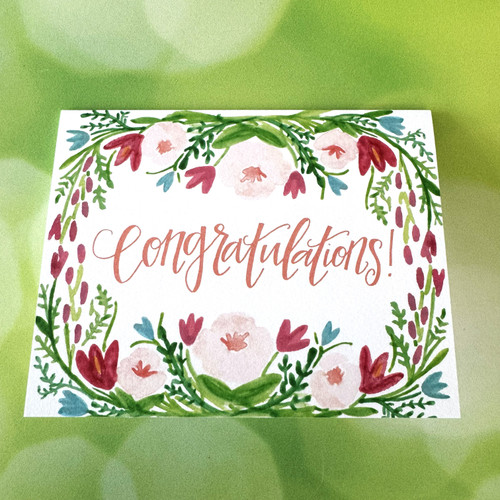 Celebrate milestones with a hand-painted floral congratulations card. Premium quality, blank inside, perfect for thoughtful gifting and special occasions.
