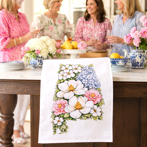 Alabama floral tea towel featuring magnolia, hydrangea, camellia, and dogwood artwork in the shape of Alabama on a decorative kitchen towel.