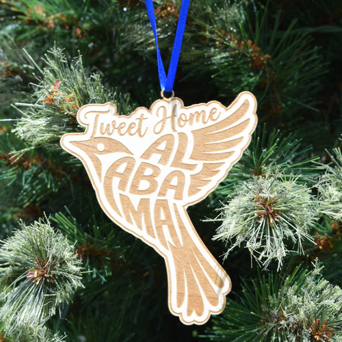 Tweet Home Alabama wooden bird ornament featuring laser-engraved lettering, natural wood finish, and hanging ribbon for Christmas tree décor and Alabama gifts. (Ribbon Color May Vary)