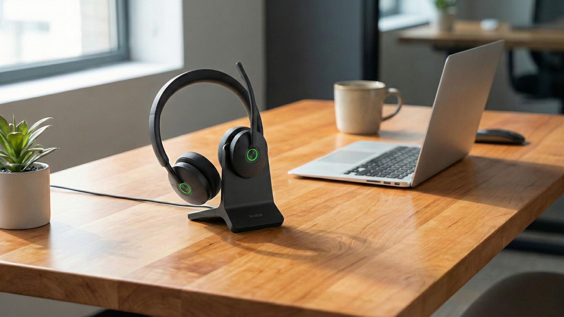 Yealink BH74 Bluetooth headset on a maple work desk.