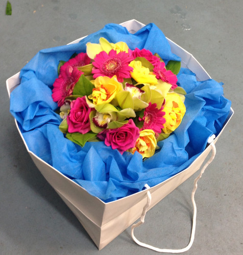 Bright bouquet including Gerberas, Double Daffodils and Orchids 
