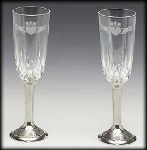 Pewter/Crystal Champagne Wedding Flute Set (Available in Plain or Claddagh).
The design is that of the Claddagh taken from the famous love symbol designed in the town of Claddagh, Co. Galway by Richard Joyce back in the year 1689. The design is often used for wedding rings as it is based on the ring that Richard made for his bride to be. The symbolisms are "hands for friendship", "heart for love" and "crown for loyalty".
A beautiful gift for the bride and groom on their big day. Pewter/Crystal Champagne Wedding Flute Set (Available in Plain or Claddagh).
The design is that of the Claddagh taken from the famous love symbol designed in the town of Claddagh, Co. Galway by Richard Joyce back in the year 1689. The design is often used for wedding rings as it is based on the ring that Richard made for his bride to be. The symbolisms are "hands for friendship", "heart for love" and "crown for loyalty".
A beautiful gift for the bride and groom on their big day.
