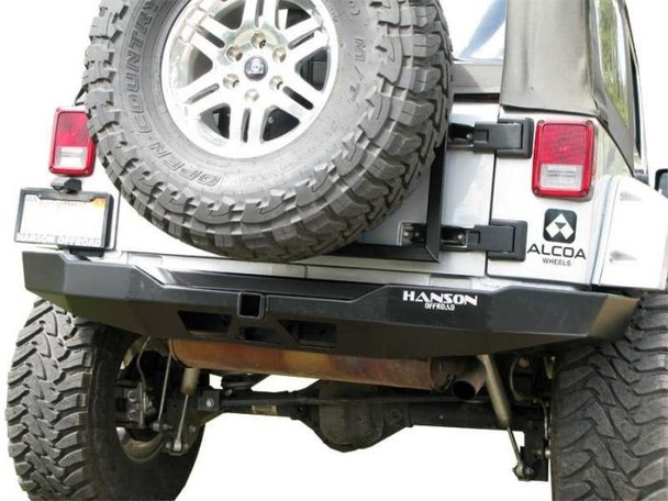 The handcrafted construction of this sturdy bumper consists of 3/16 cold rolled steel and frenched-in 2 receiver hitch. The combination of sturdy construction and multiple angles adds strength and optimizes departure angles. This bumper wraps around the rear body with a thinner profile than stock bumpers. Integrated hitch does not interfere with ground clearance or departure angles. Powder coated in black semi-gloss finish. Hanson's rear bumper works w/stock size tires, if you are going to run larger than stock we suggest our tire carrier.