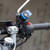 Quad Lock motorcycle handlebar mount fitted to a bike, showing secure phone positioning for navigation.