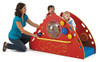 woman playing with 2 children who are on a small playset