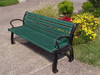 Green recycled plastic park bench with colorful flowers behind it