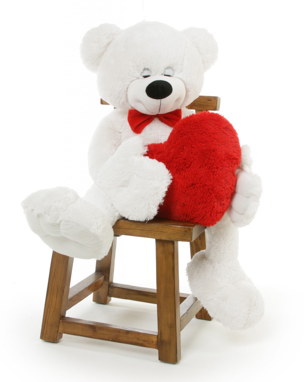 white teddy bear holding a heart