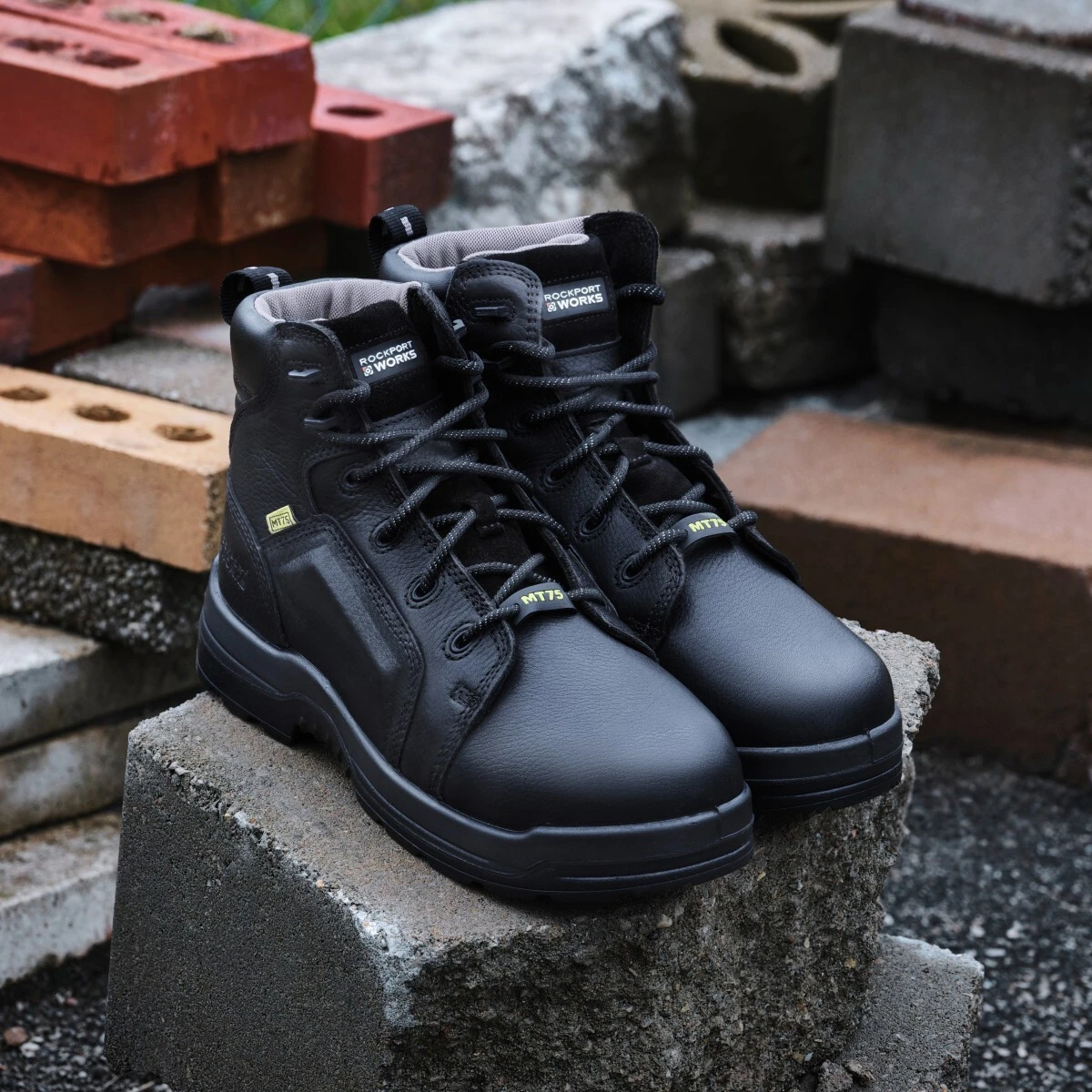 rk6465-more-energy-rockport-works-28-1200x1200.jpg Rockport metatarsal boots sitting next to a pile of bricks.