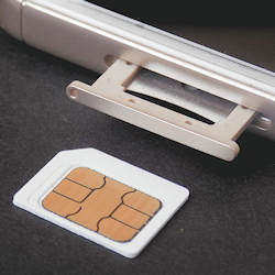 Nano SIM card next to a smartphone SIM card tray