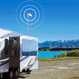 weBoost Connect RV 65 outside LPDA deployed behind a fifth wheel at a mountain lake