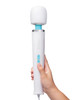 Le Wand Classique Plug-In Wand Massager held in hand, featuring a soft silicone head, sleek white handle, and easy vibration controls.