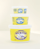 Three containers of Boy Butter Original lubricant stacked by size (small, medium, large) on a neutral background, with the yellow label clearly visible on each tub.