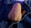 Uncut packer shown inside jeans with a warm tan skin tone with lifelike detailing, including visible veins, natural wrinkles, and a clearly defined foreskin. Designed with a balanced shape and realistic proportions for everyday packing.