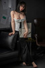 IronTech Miya 5'5 platinum silicone sex doll standing in black pants and white corset