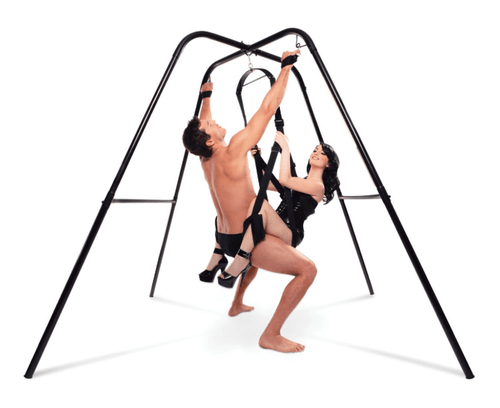 Couple in a bedroom using a sex swing stand, showcasing freestanding frame and supported positioning during intimate play