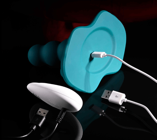 Playboy Have a Seat vibrator with USB charging cable showing beaded shaft and flat base design