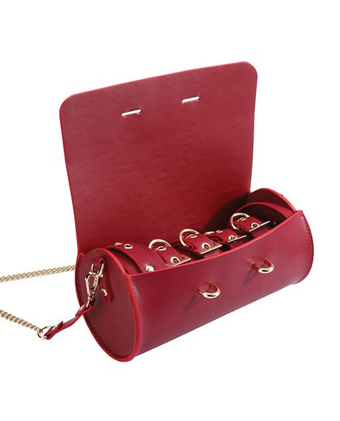 Looks like a designer bag. Acts like a bondage kit. Wrist cuffs, ankle cuffs, collar, and leash—portable kink for people who like compliments and control.