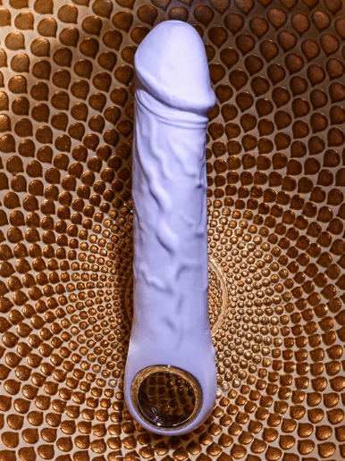 Purple Fantasy Realistic Vibe top-down product image showing a purple realistic vibrator with textured shaft detailing, rounded head, and chrome ring base placed on a woven brown surface.