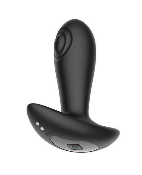 Angled close-up of the Reggie Remote Tapping Anal Plug highlighting the curved ergonomic shape and dual side bullet placement. The smooth black silicone body and wide safety base are clearly visible against a white background.